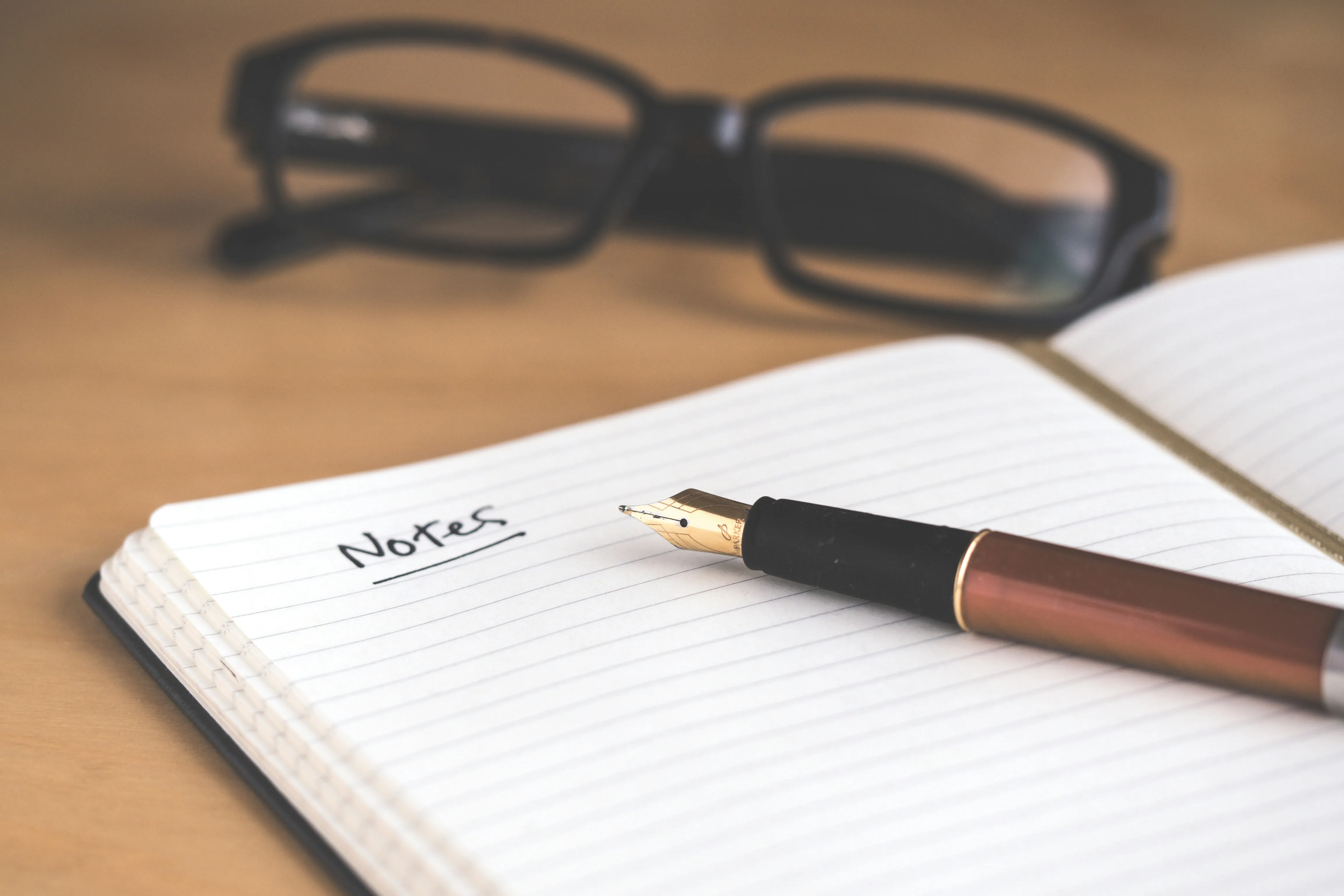 person writing bucket list on book